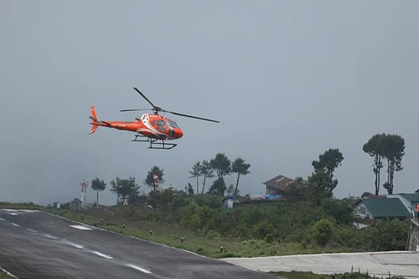 A helicopter approaching to land in Lukla during the Everest luxury trek